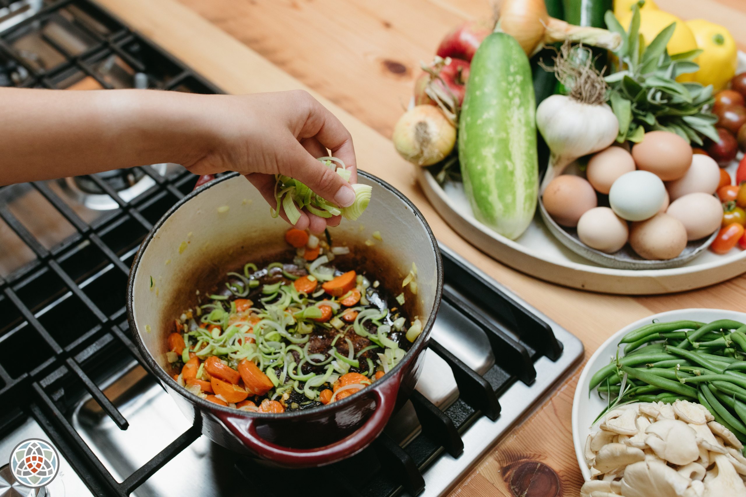 Hand over pot on stove cooking nutritious food